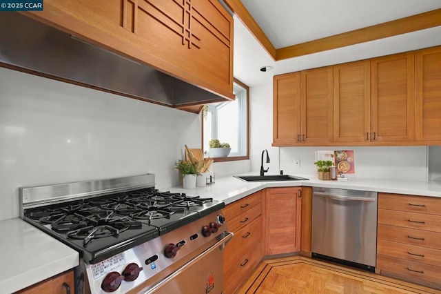 kitchen featuring sink, exhaust hood, light parquet floors, and appliances with stainless steel finishes