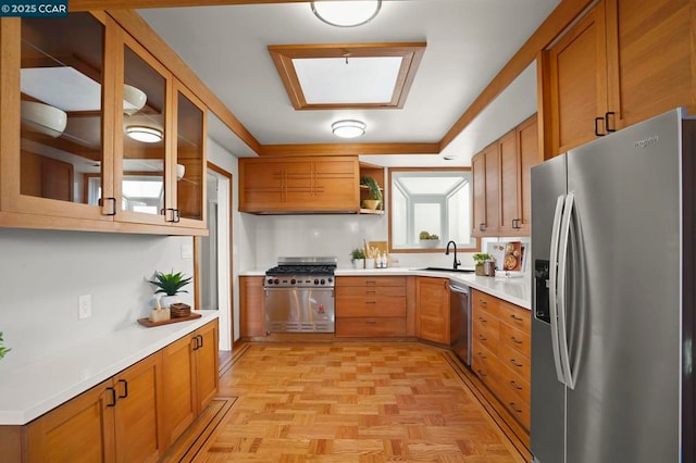 kitchen with stainless steel appliances, light parquet flooring, sink, and premium range hood