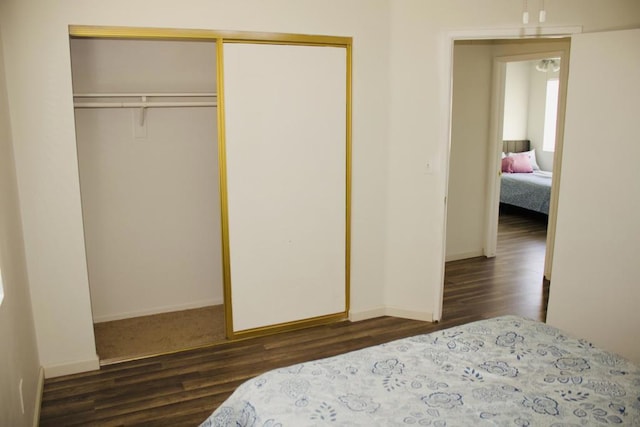 bedroom featuring a closet and dark hardwood / wood-style flooring