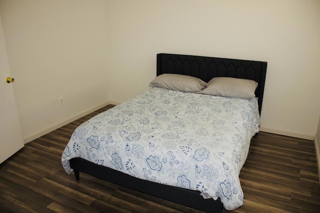 bedroom with dark wood-type flooring