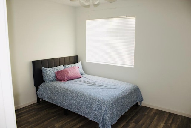 bedroom with ceiling fan and dark hardwood / wood-style flooring