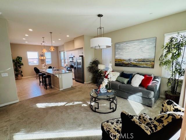 living room featuring sink and light carpet