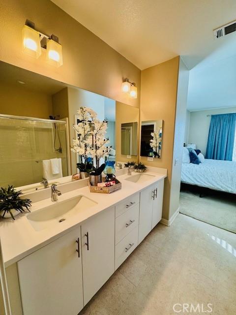 bathroom with an enclosed shower and vanity