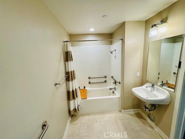 bathroom with sink and shower / bathtub combination with curtain