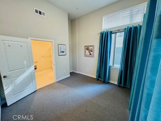 empty room with dark colored carpet