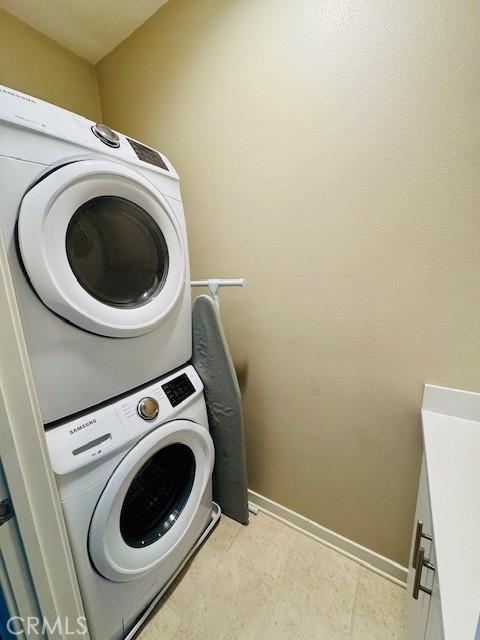 laundry area featuring stacked washer and dryer