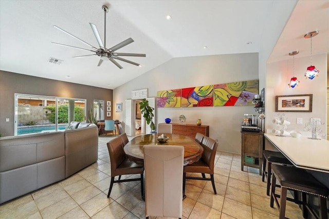 dining area with lofted ceiling, light tile patterned floors, and ceiling fan