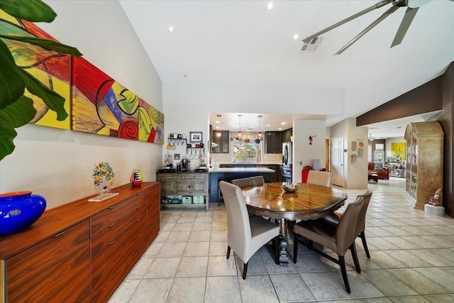 dining space featuring light tile patterned flooring, lofted ceiling, and ceiling fan