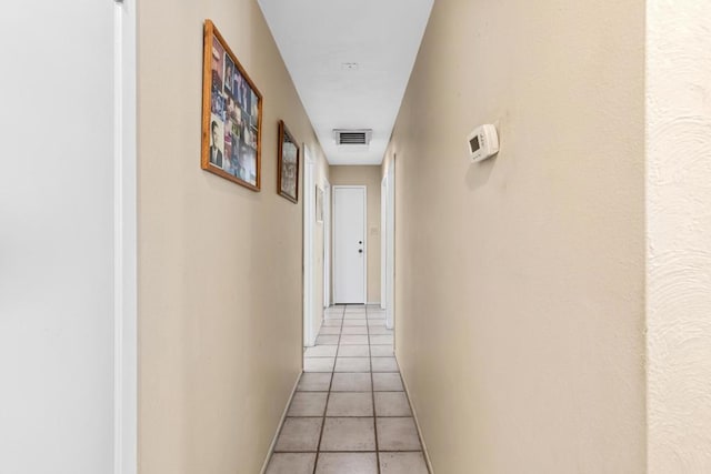 corridor featuring light tile patterned floors