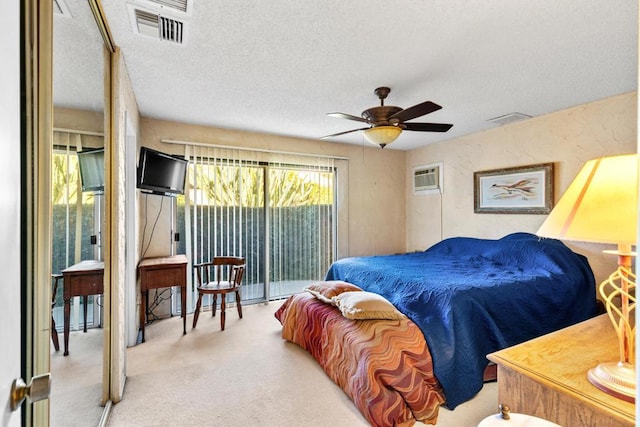 carpeted bedroom featuring a textured ceiling, access to exterior, a wall unit AC, and ceiling fan