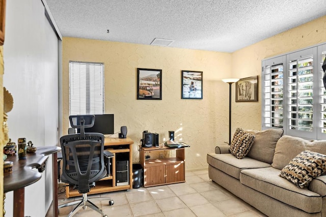 office featuring a textured ceiling and light tile patterned floors