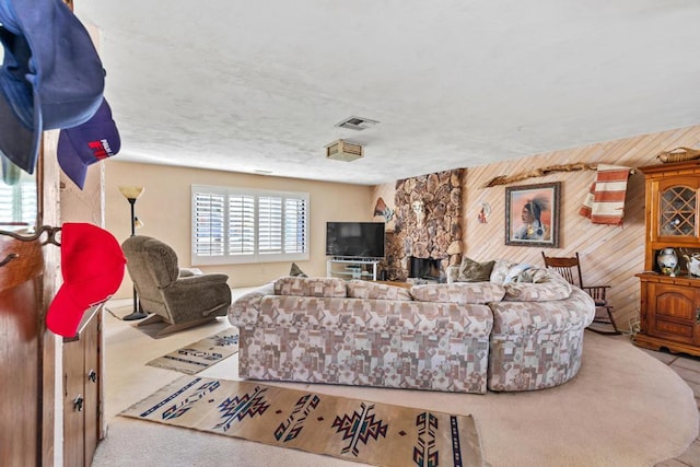 living room featuring wood walls and carpet flooring