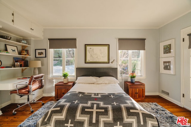 bedroom with ornamental molding, dark hardwood / wood-style floors, and multiple windows