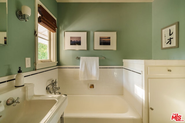 bathroom with sink and a bath