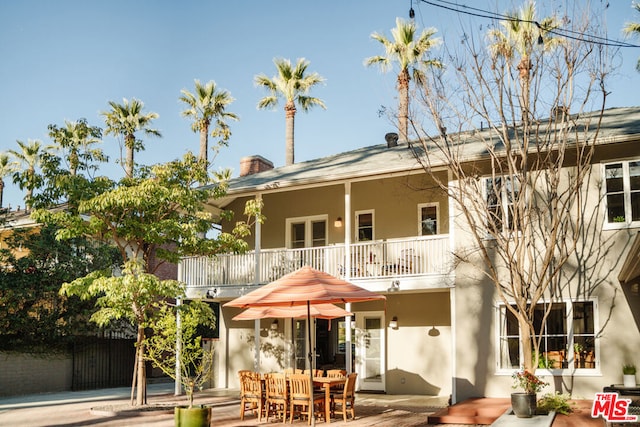 back of house featuring a patio and a balcony