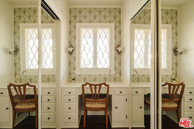 interior space with ornamental molding and built in desk