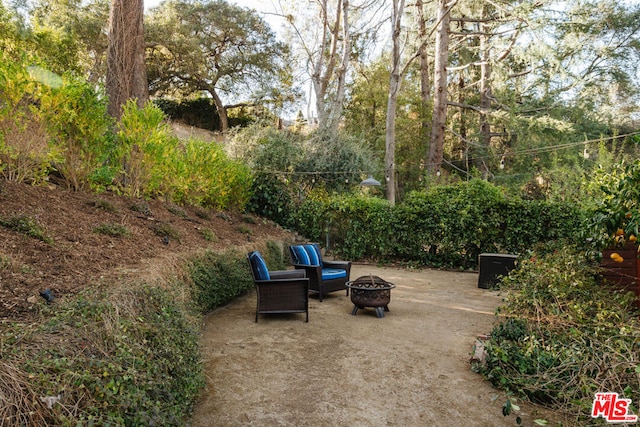 view of patio / terrace with an outdoor fire pit