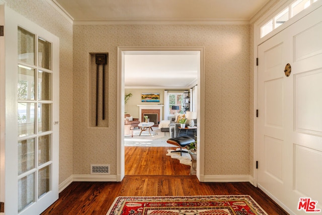 hall with ornamental molding and dark hardwood / wood-style flooring