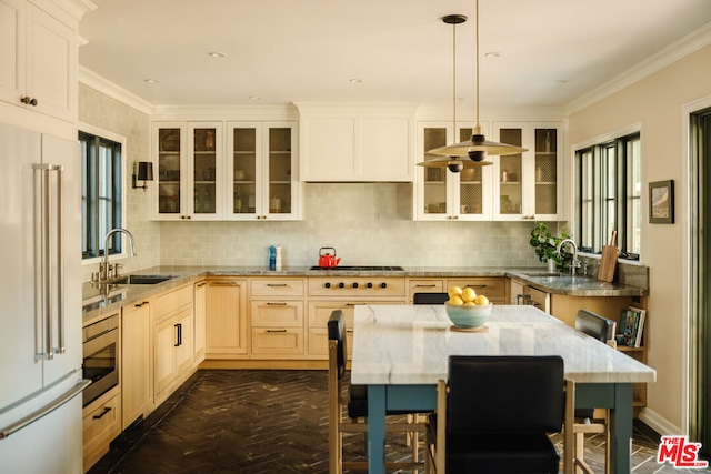 kitchen with decorative backsplash, high quality fridge, sink, and hanging light fixtures