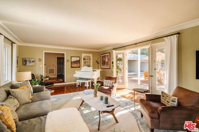 living room featuring french doors, ornamental molding, and hardwood / wood-style floors