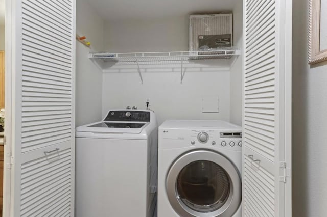 washroom featuring washer and clothes dryer