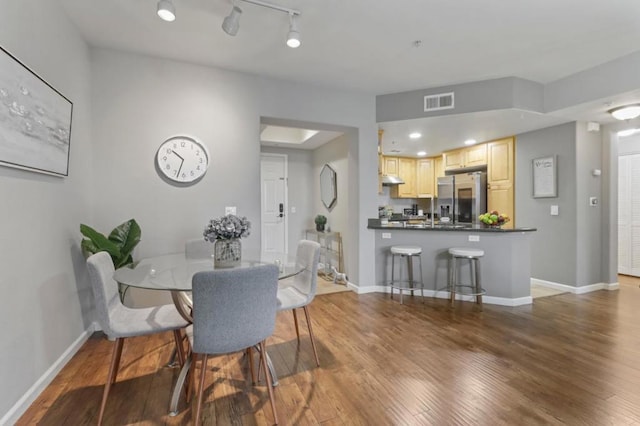 dining room with dark hardwood / wood-style flooring