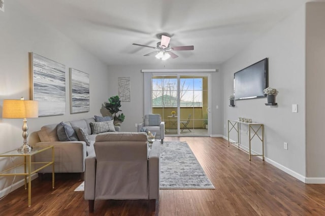 living room featuring ceiling fan and dark hardwood / wood-style flooring