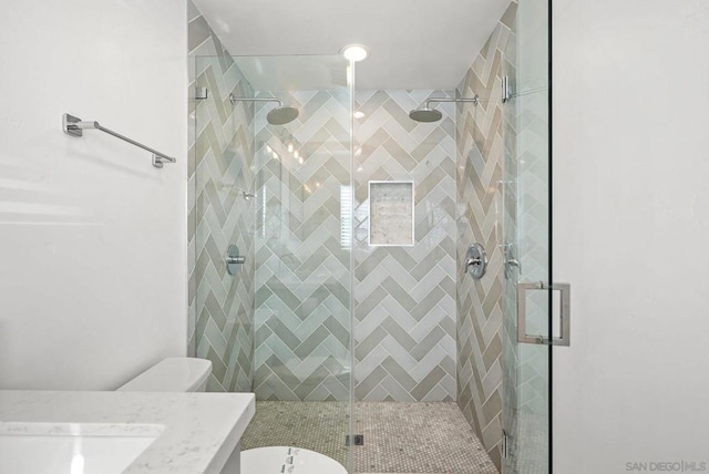 bathroom with vanity, toilet, and an enclosed shower