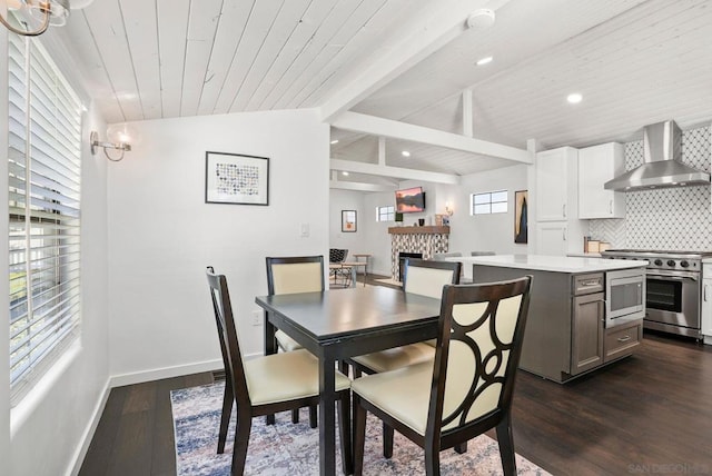 dining space featuring a tiled fireplace, wood ceiling, vaulted ceiling with beams, and dark hardwood / wood-style flooring