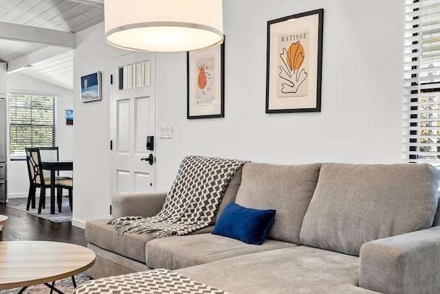 living room featuring vaulted ceiling with beams and wood-type flooring