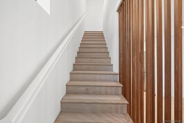 stairs with a skylight