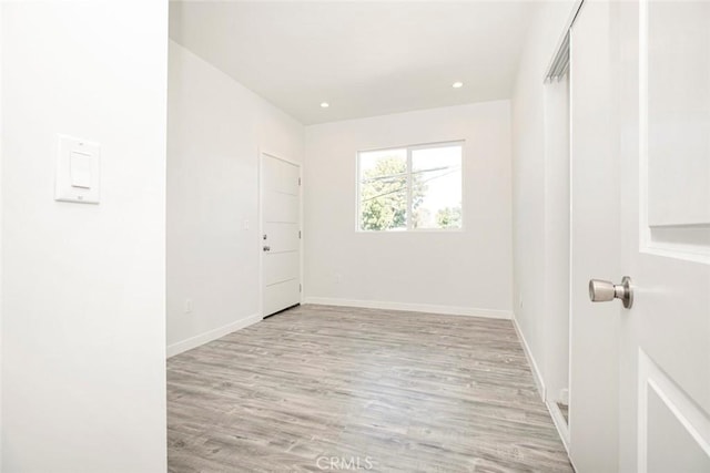 unfurnished room with light hardwood / wood-style floors