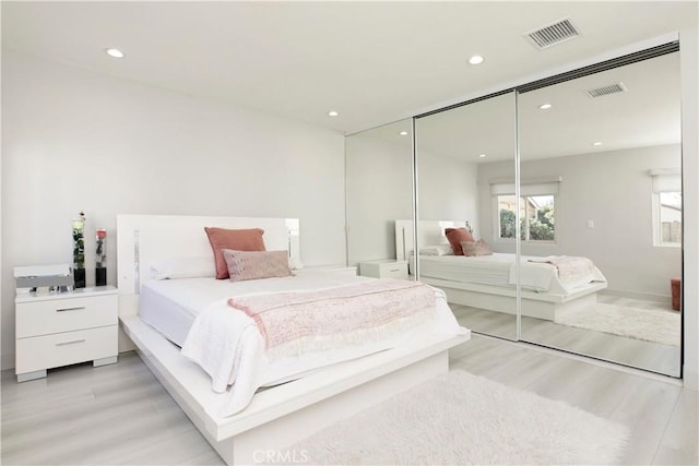 bedroom featuring light hardwood / wood-style flooring and a closet