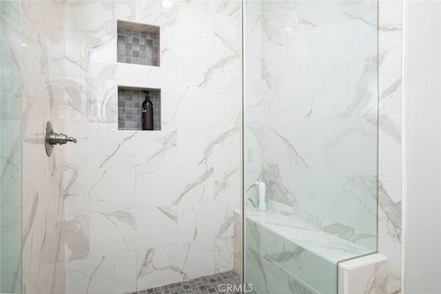 bathroom with a tile shower