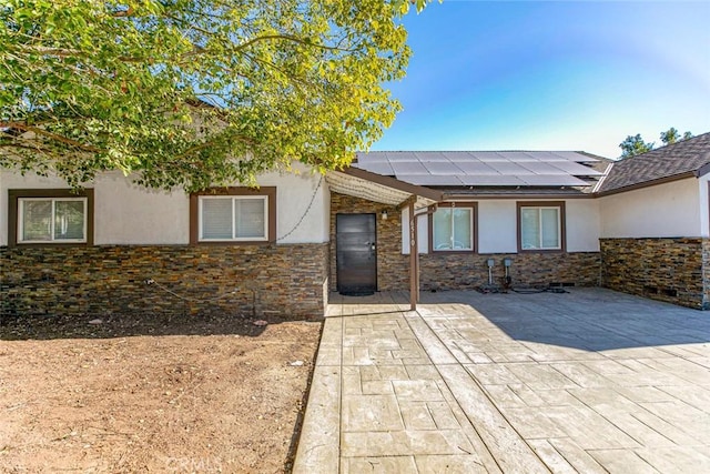 view of exterior entry with solar panels