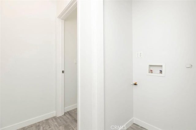 laundry area featuring hookup for a washing machine and light hardwood / wood-style floors