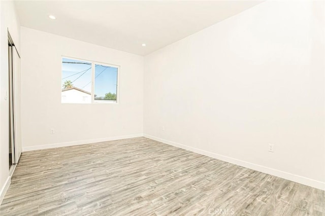 spare room featuring light hardwood / wood-style flooring