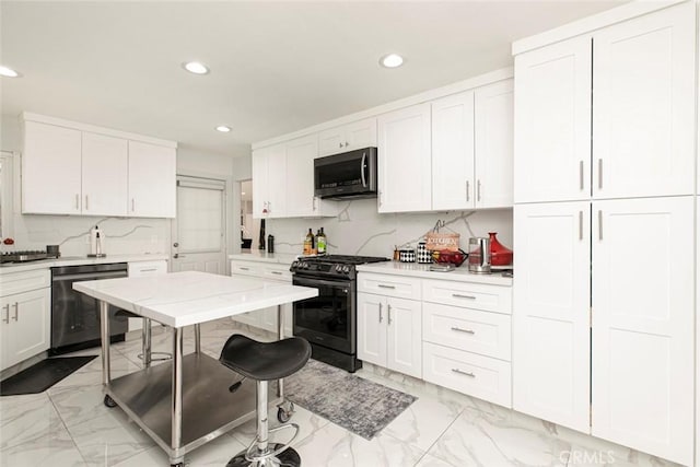 kitchen with white cabinets, appliances with stainless steel finishes, and tasteful backsplash