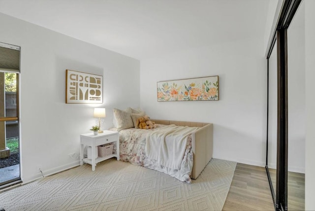 bedroom featuring access to outside and light hardwood / wood-style flooring