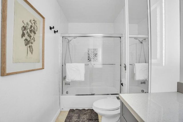 full bathroom featuring vanity, shower / bath combination with glass door, and toilet