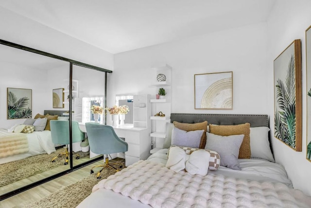 bedroom with wood-type flooring and a closet