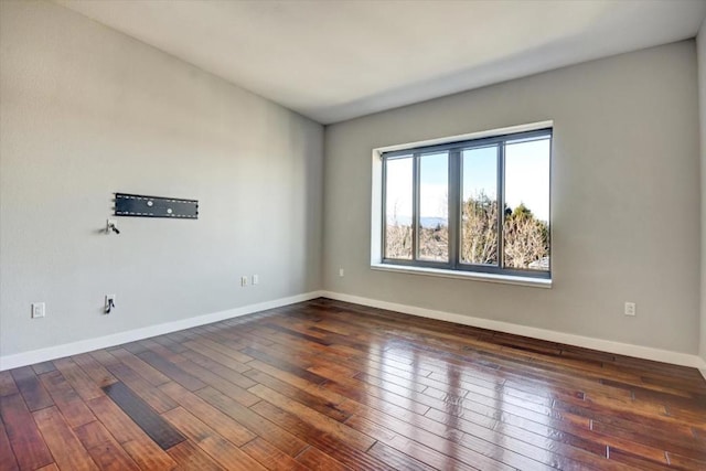 spare room featuring dark hardwood / wood-style floors