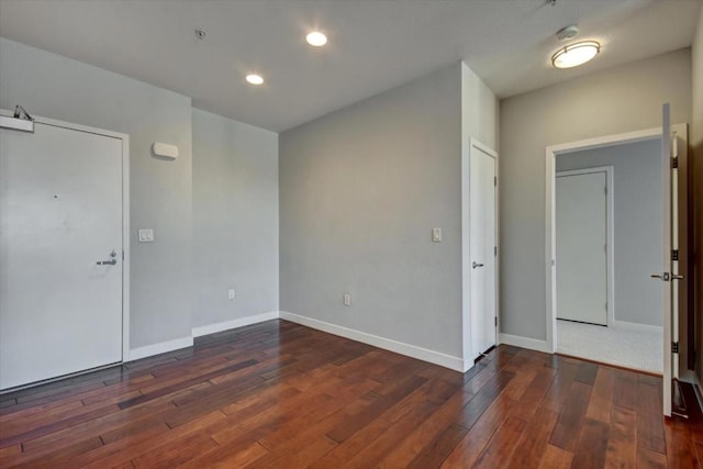 empty room with dark hardwood / wood-style flooring