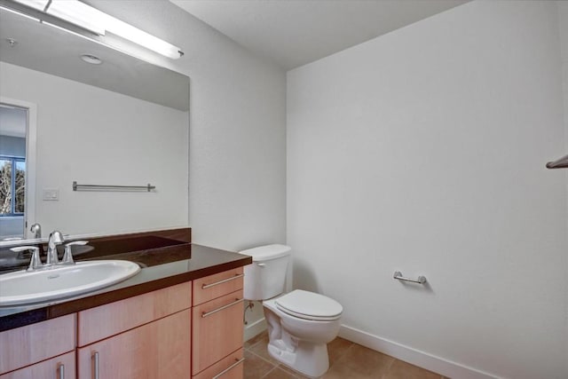 bathroom with vanity, tile patterned floors, and toilet