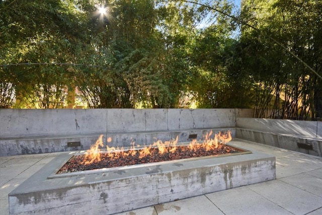 view of swimming pool featuring an outdoor fire pit