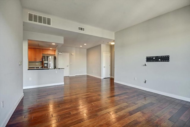 unfurnished living room with dark hardwood / wood-style floors