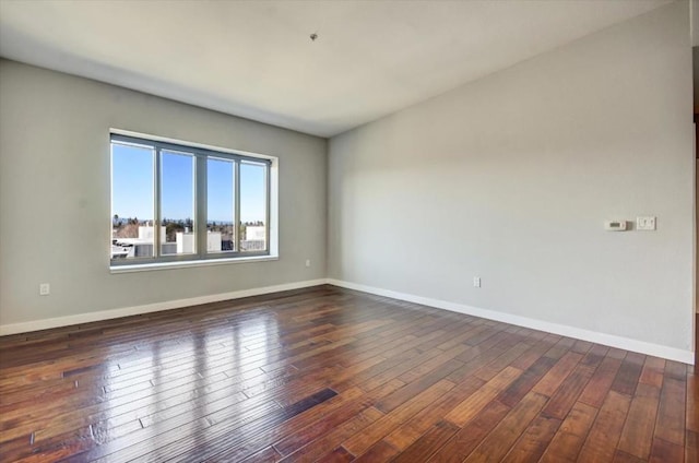 unfurnished room with dark hardwood / wood-style floors