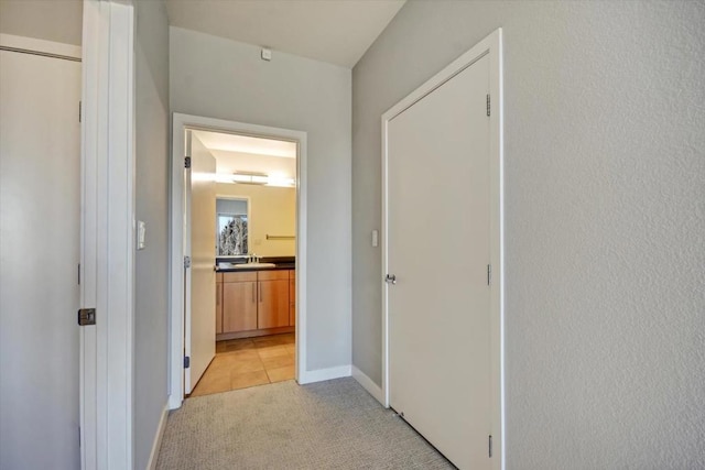 hall with light colored carpet