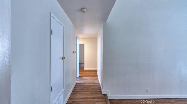 hallway with dark hardwood / wood-style floors