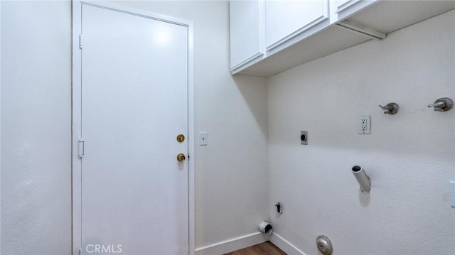 laundry area featuring electric dryer hookup, cabinets, hardwood / wood-style floors, and hookup for a gas dryer